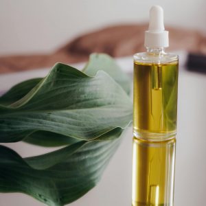 Oil in a Bottle with a Pipette and a Leaf